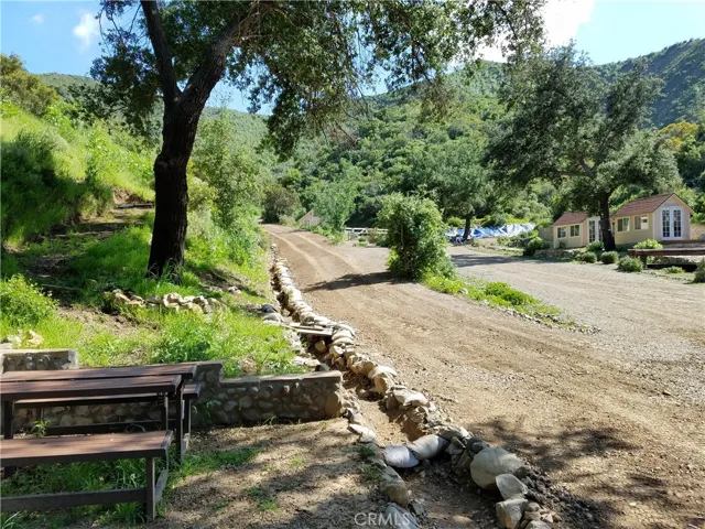 Beige/yellow outbuildings no longer on property. Pictures shown for reference to where the best pads for staging are.