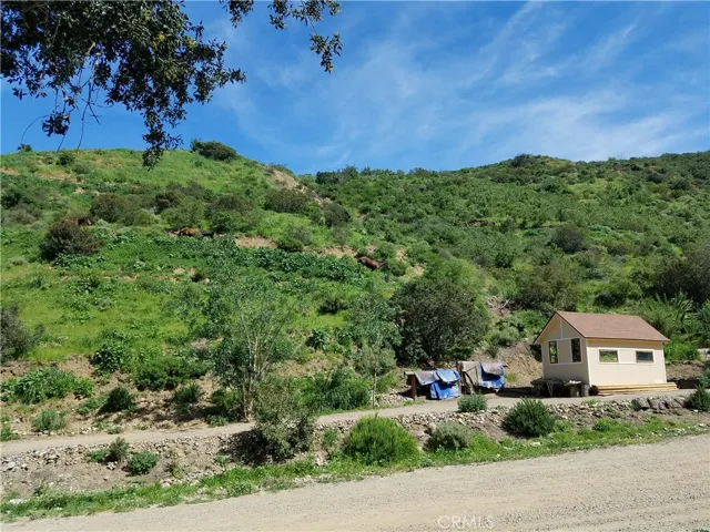 Beige/yellow outbuildings no longer on property. Pictures shown for reference to where the best pads for staging are.