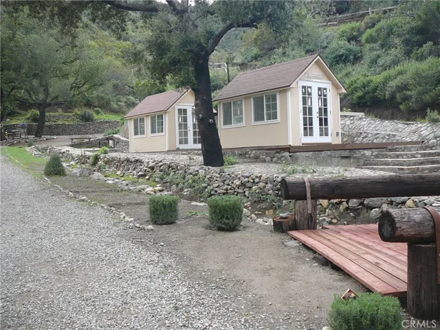 Beige/yellow outbuildings no longer on property. Pictures shown for reference to where the best pads for staging are.