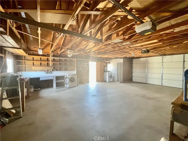 The oversized garage has a roll up door at each end.