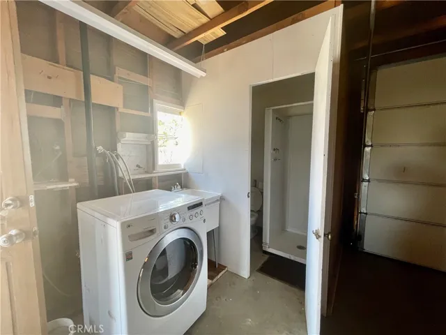 Bathroom in garage has a shower.