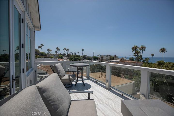 Spacious balcony with patio furniture.