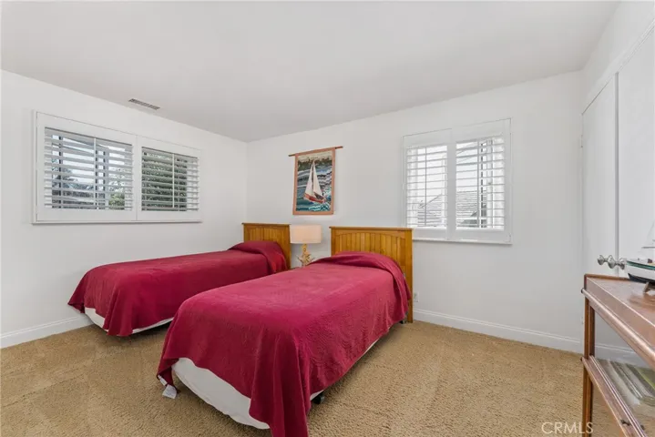 Nicely sized secondary bedroom with plantation shutters and plush carpet.