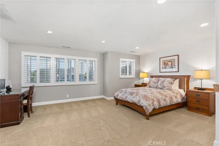 HUGE bonus room with plantation shutters, scraped ceilings and plush carpet.