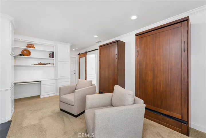 Downstairs den/bedroom with stylish barn door and two Murphy beds