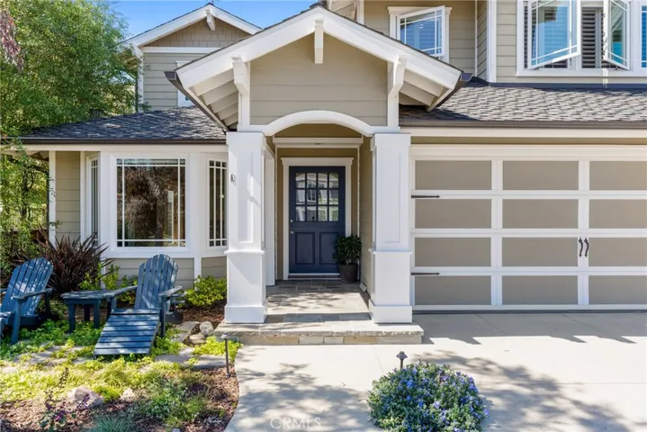 Notice the wrapped entry columns and stone walkway approaching the front door.