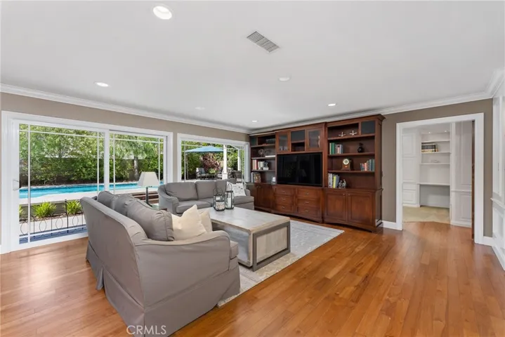 A family room with a built-in cherrywood entertainment center awaits.