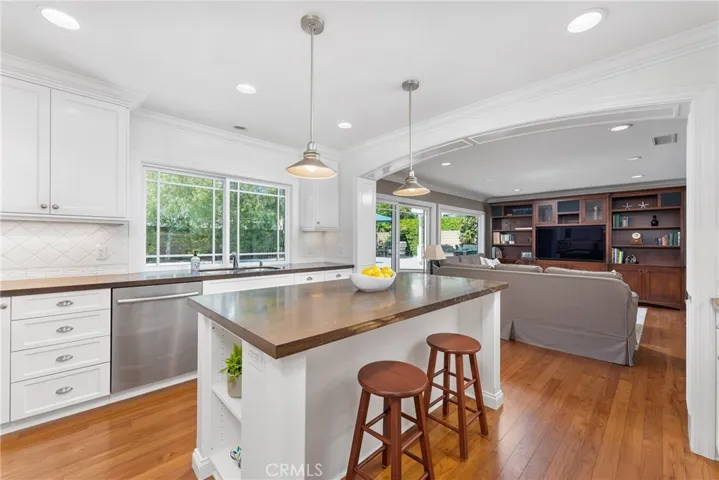 White shaker style cabinetry and copper lignio granite countertops.
