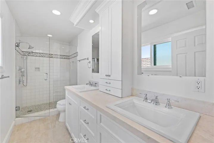 Pamper yourself in the elegance of your primary suite bathroom with dual sinks and a glass enclosed step-in shower.