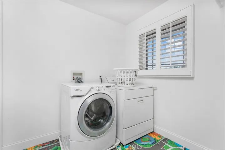 Upstairs laundry room is convenient.