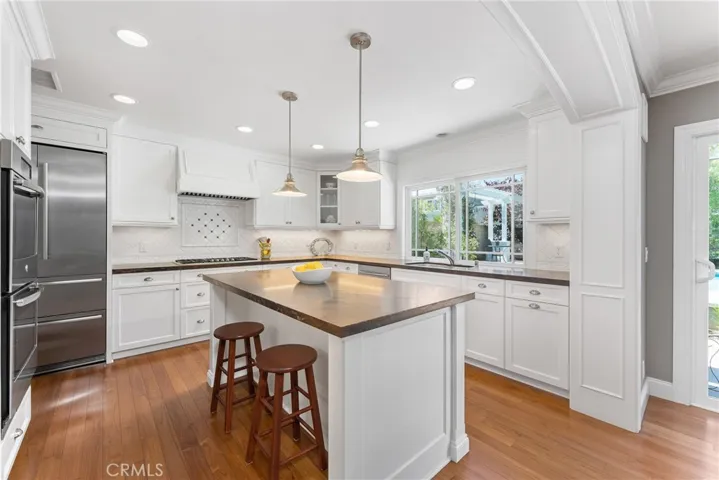 Stainless steel appliances including a built-in fridge and double oven.
