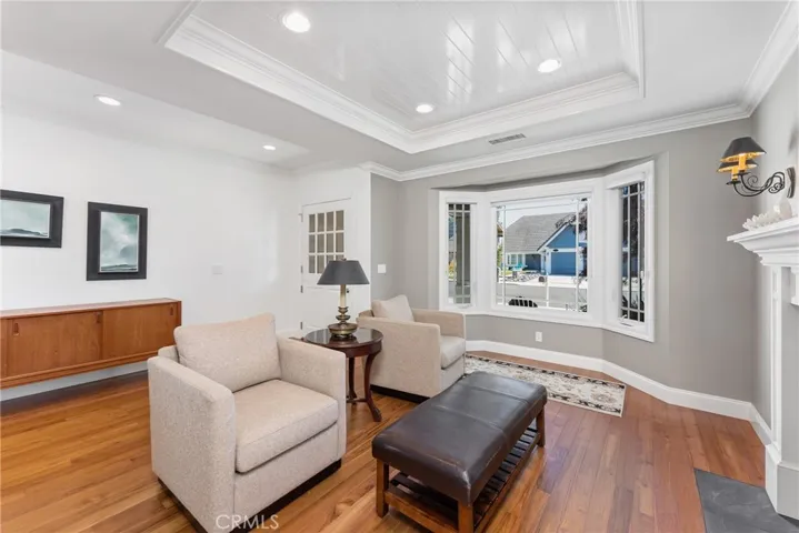 Elegant teakwood floors and crown molding throughout. Modern design meets beachside charm in this home.