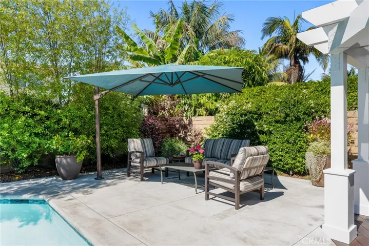 Built-in umbrella provides additional shade and this area has been plumbed for a potential fire pit or BBQ.