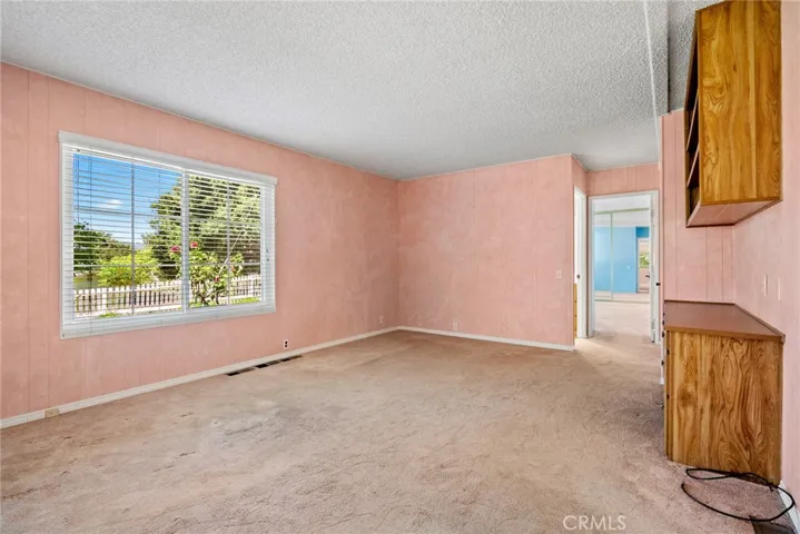 The family room is bathed in more natural light thanks to the large window that overlooks the front yard.