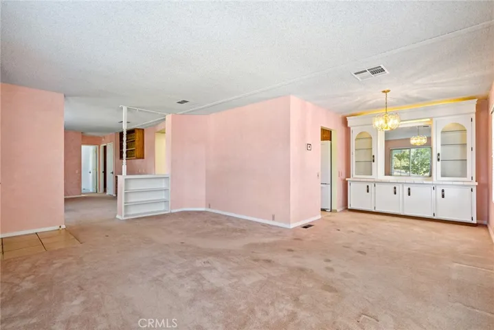 The living room offers space to spread out and flows into the dining area. The dining area has a lovely built in hutch that is lighted for storage.