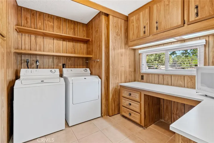The laundry room features a built in desk with cabinets above plus lot of storage.  Washer and dryer stay!
