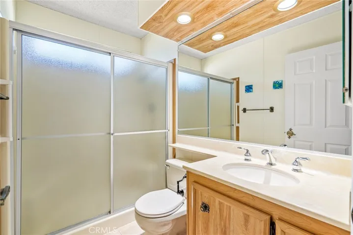 The main bathroom offers a large vanity and walk in shower.