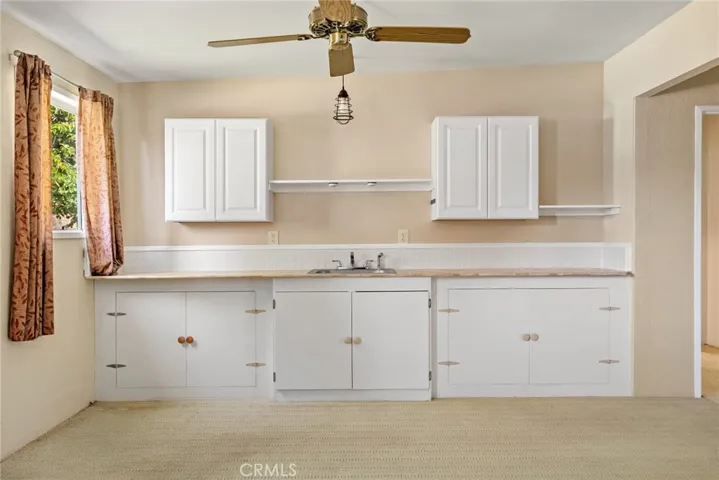 The secondary building has an apartment with a large kitchenette area.