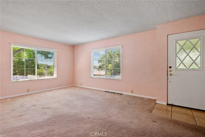 Entering the home you find yourself in the living which has two large windows that usher in the natural light.