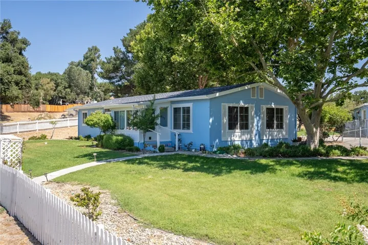 Well maintained home sits back from the street and is surrounded by pristine landscaping.
