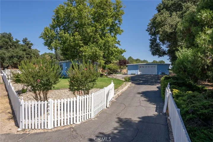 Quaint white picket fence lines the front of the property and welcomes you to the property.  There is also a manual gate you can close.