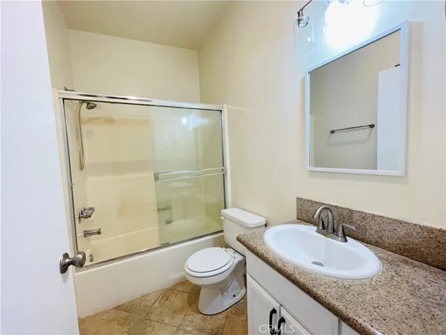 Full bathroom two with washer/dryer behind the door