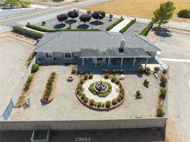 Drone view showing private yard with block wall