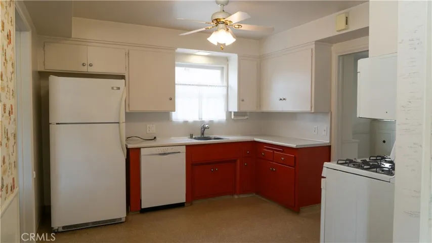 Kitchen with refrigerator, dishwasher, and gas range
