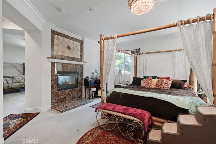 Master bedroom and fireplace with view to master retreat