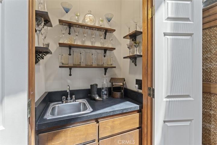Nothing says entertainment like a wet bar, hidden behind the dual solid doors.