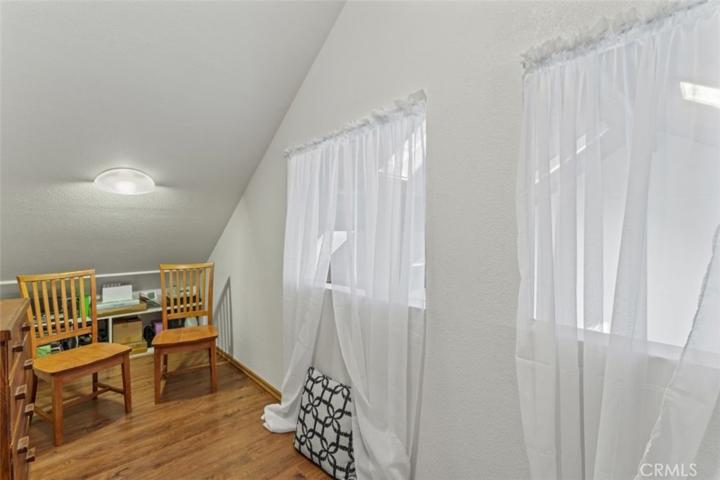 Across the hall you will find this darling office, overlooking the living room area.