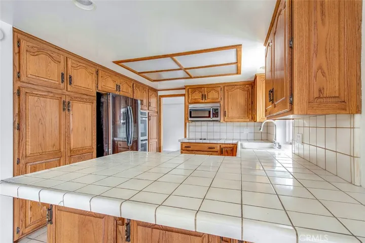 Large kitchen counter with 'L' for prepping, serving and sitting