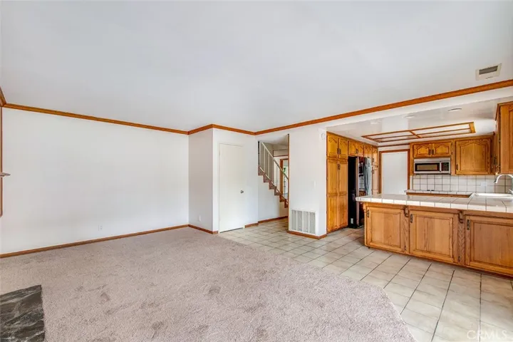 View from family room to kitchen and stairs to bedrooms