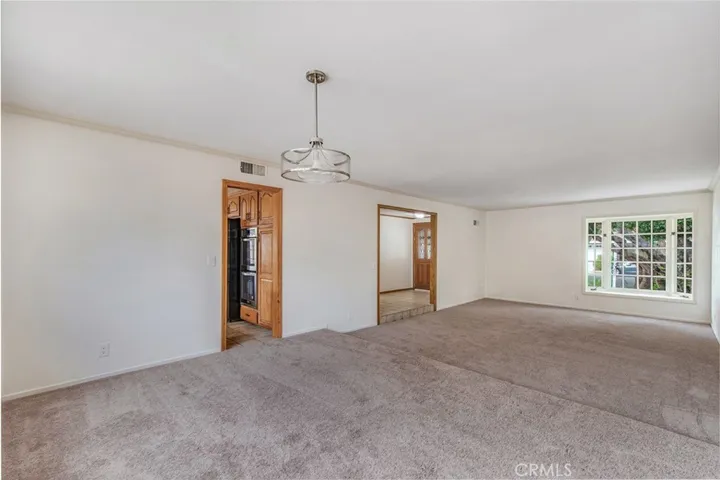View from dining area to kitchen and front entry way