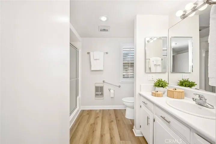Spacious bath with new flooring and paint.