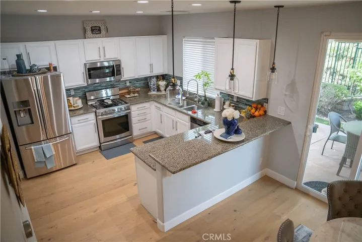 Stainless steel appliances, granite counter tops, wood floors