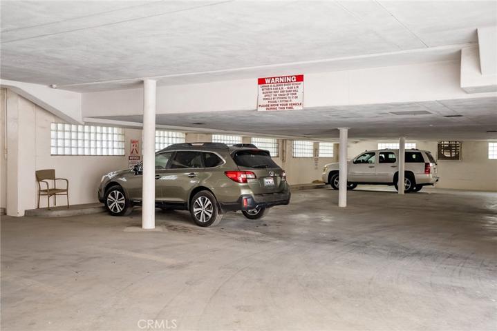 Subterranean garage that has two parking spots for unit