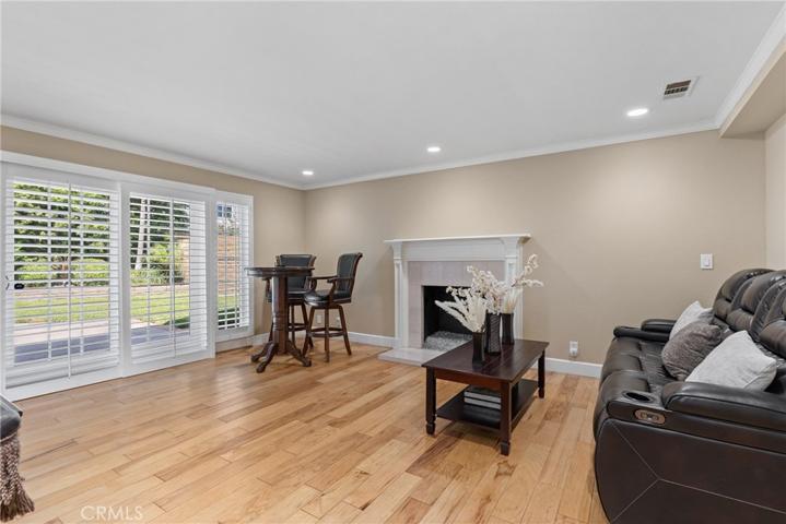 Enjoy recessed lighting and two sliders to the backyard with plantation shutters!