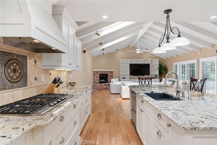 Enjoy the large center island, breakfast bar, plenty of white shaker style cabinetry and lighted cabinets!