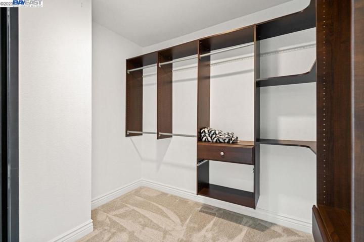 Organized walking closet located at master bedroom.
