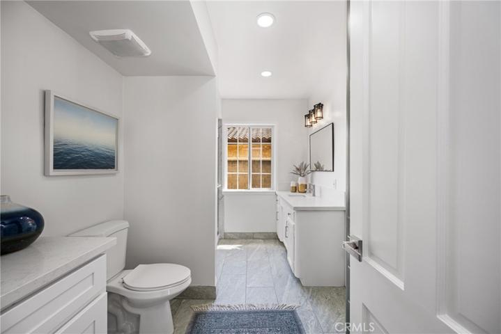 Primary bathroom has access from hallway for guests