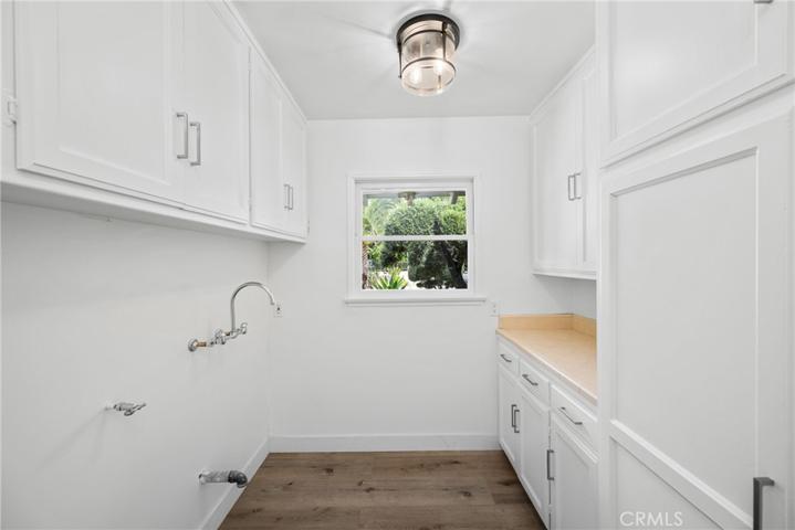 Large laundry room with sink hook up and storage