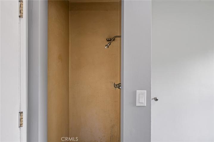 Shower off of garage shares wall with bedroom #3