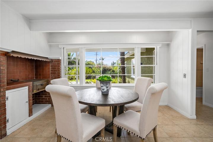 Informal dining in kitchen looks out to backyard