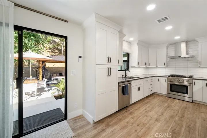 Main home kitchen with slider door access to yard