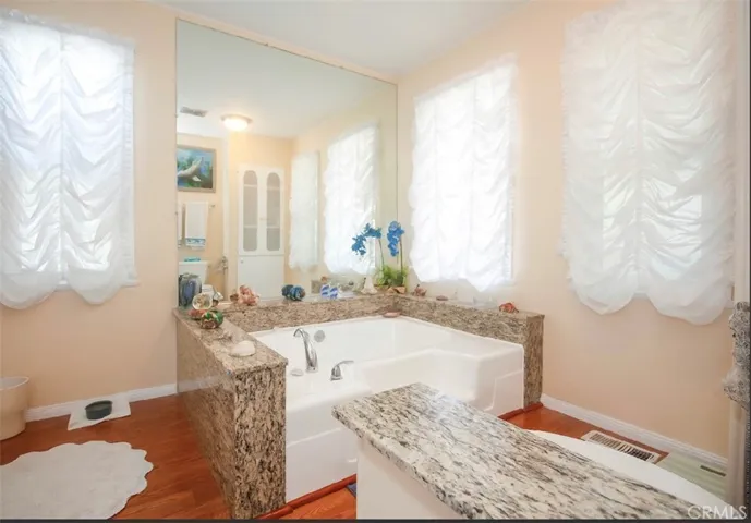 Master bathroom with granite tub and lots of cabinets