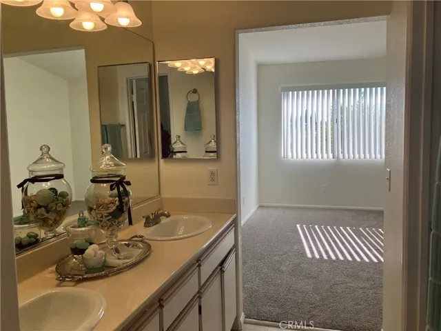 Primary Bedroom, double vanity sink and window view.