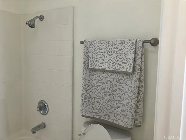 Primary Bedroom bathtub, towel rack near bathtub/toilet area.