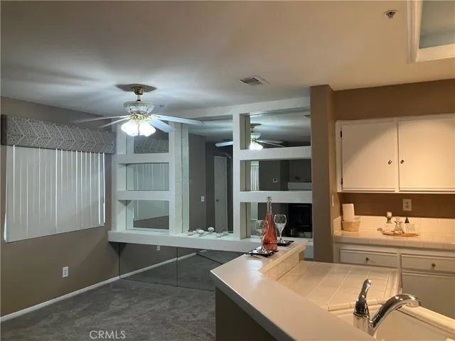 Eating area, ceiling fan, mirrored wall with shelves for your decorations!