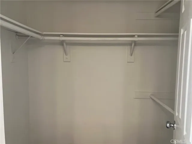 Primary Bedroom Walk In closet, near double vanity sink.